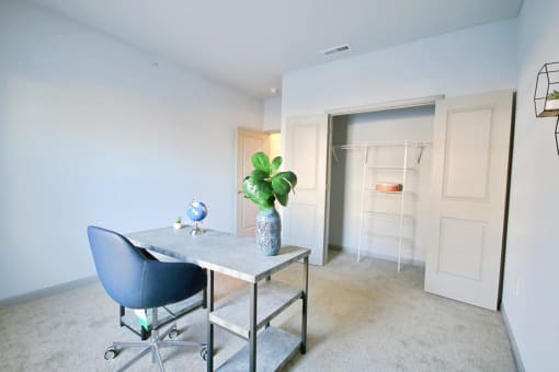 a home office with a desk and a closet
