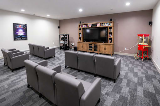 A living room with grey couches and a television.