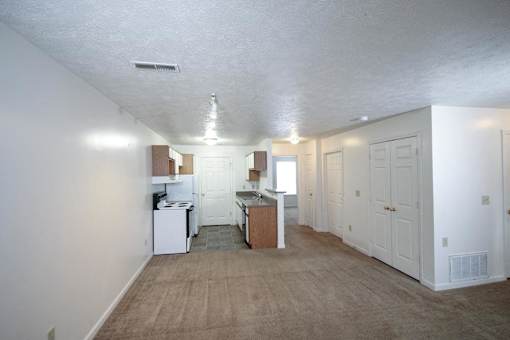 A kitchen area with white appliances and cabinets.