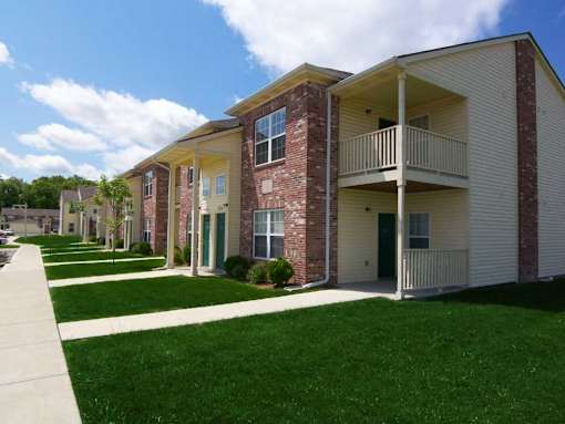Apartment building with a green lawn in front.