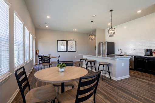 Clubhouse kitchen with tables, chairs, and appliances in the background