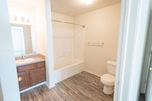 A bathroom with a toilet, sink, and shower.