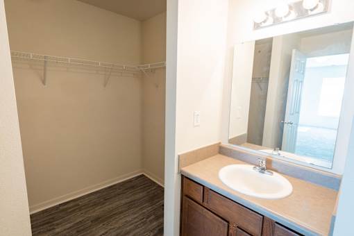 A bathroom with a sink and a mirror.
