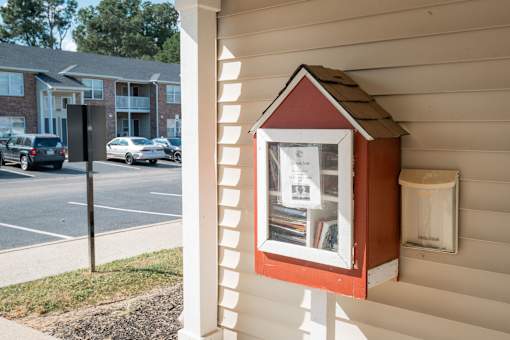 A small red and white building is attached to a house.