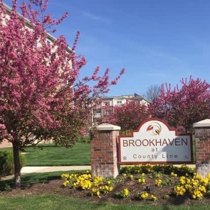 A sign that says Brookhaven stands in front of a building.