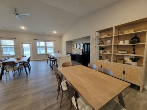 a dining room and living room with a table at Southern Meadows Apartments