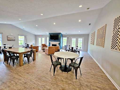 A spacious room with a fireplace and a television.