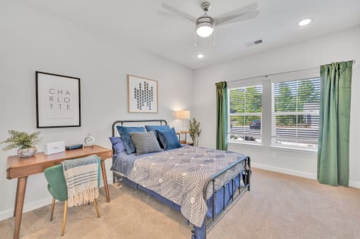 a bedroom with a bed and two windows