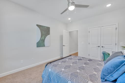 a bedroom with a large bed and a ceiling fan