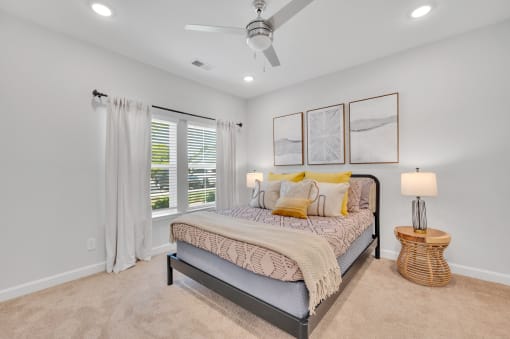 a bedroom with a bed and a ceiling fan