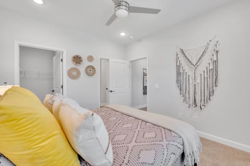 a bedroom with a bed and a ceiling fan