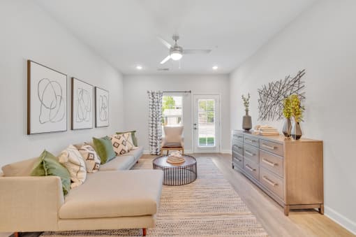 a living room with furniture and a ceiling fan