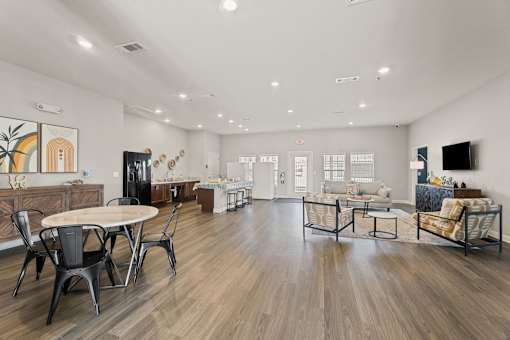 A spacious living room with a dining table and chairs.