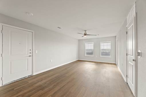 A room with wooden floors and white walls.