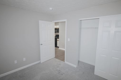 A room with a carpeted floor and white walls.