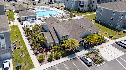 an aerial view of swiftwater apartments  with a pool in the middle.