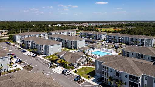 an aerial view of swiftwater apartments  with a pool in the middle.