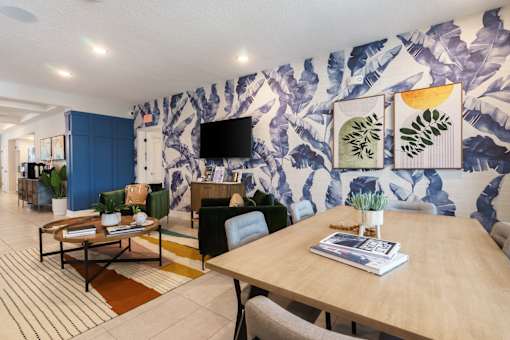 A living room with a wooden table and a blue couch.