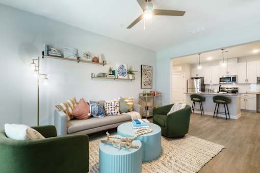 A living room with a couch, chairs, and a coffee table.