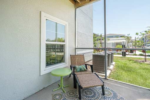 A patio with a green table and a brown bench.