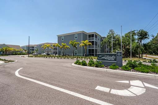 Entrance to Swiftwater apartments with a sign in the grass
