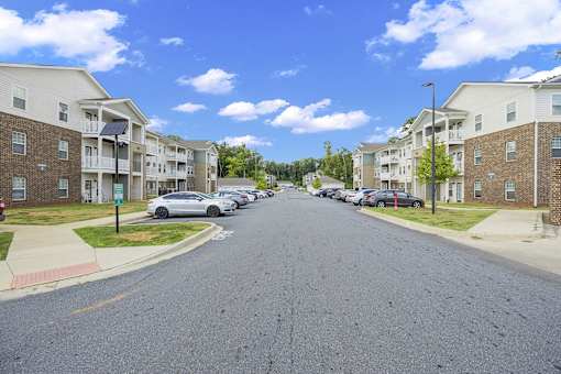 A street view of a residential area with apartment buildings on both sides.