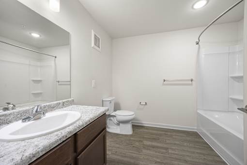 A bathroom with a sink, toilet, and bathtub.