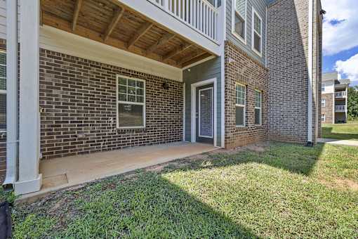 A brick house with a wooden porch.