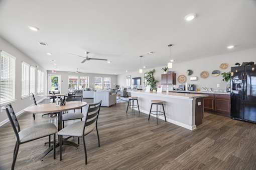 A modern kitchen with a dining table and chairs.