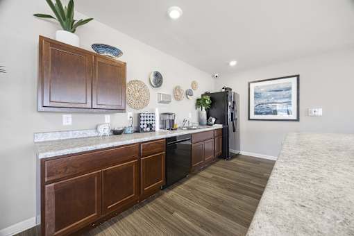 A kitchen with wooden cabinets and a fridge.