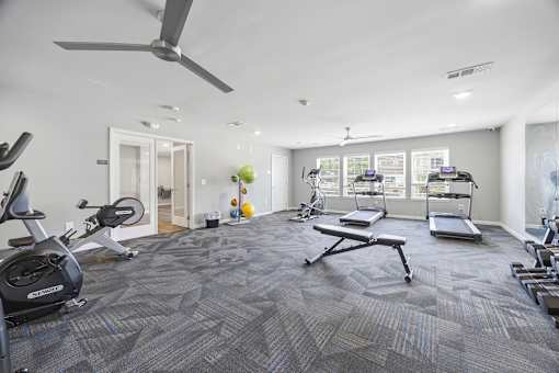 A spacious gym with a variety of exercise equipment.