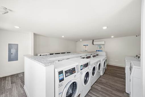 A row of washing machines in a laundry room.