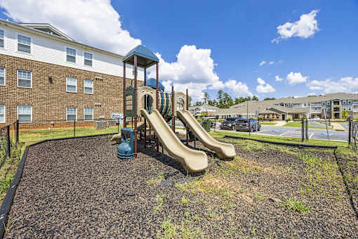 A playground with a slide and a blue slide.