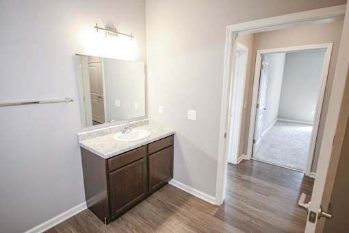 A bathroom with a sink and mirror.