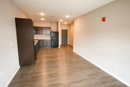 A kitchen with a refrigerator, oven, and cabinets.