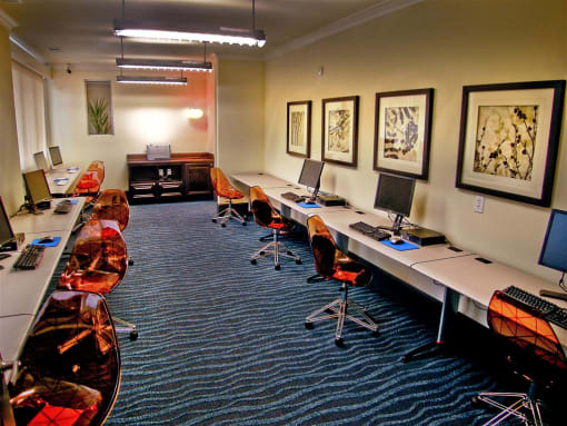 a room with a long table with computers on it