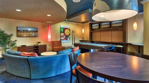 a living room filled with furniture and a ping pong table
