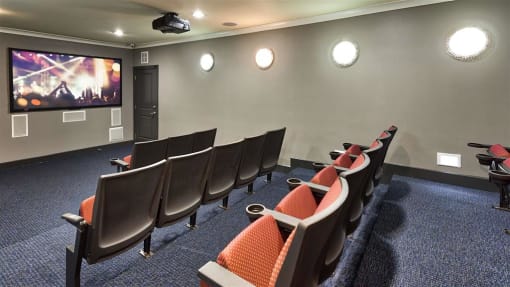 a room filled with lots of chairs and a flat screen tv