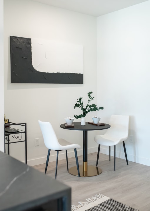 a small dining room with a table and chairs