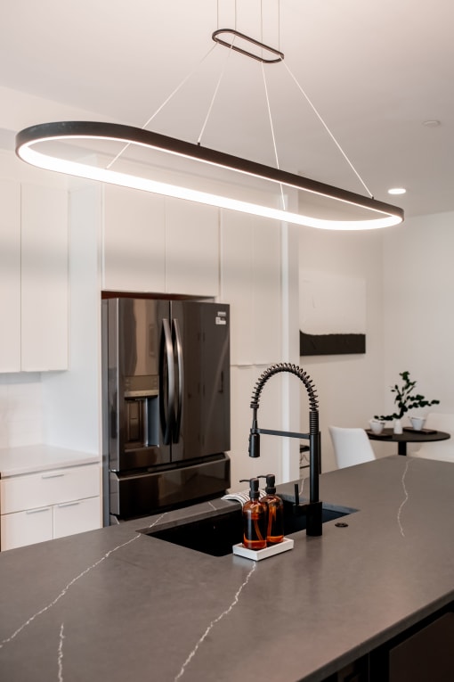 a kitchen with a black counter top and a sink