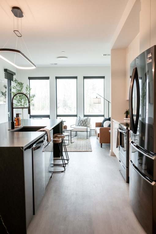 a view of a kitchen and living room from the center of the room