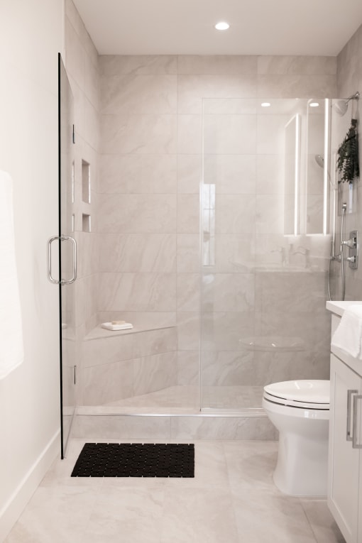 a white bathroom with a shower and a toilet