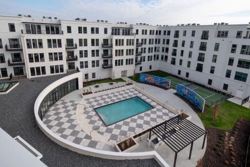 an aerial view of an apartment building with a swimming pool