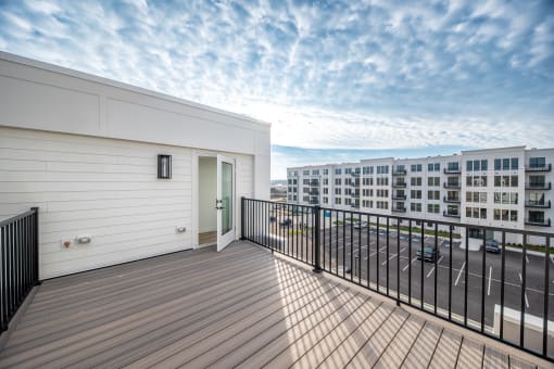 a balcony with a view of a building and a blue sky