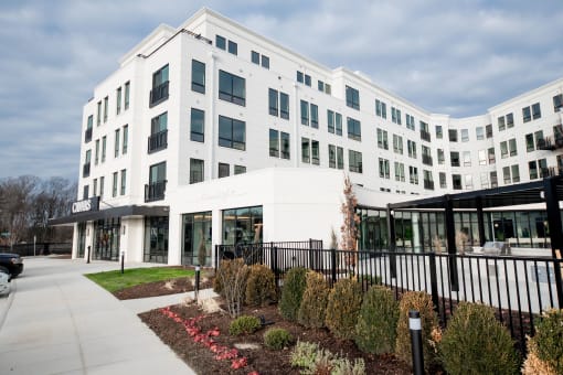 a white building with a sidewalk in front of it