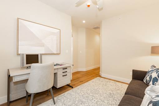 A room with a desk and a couch.