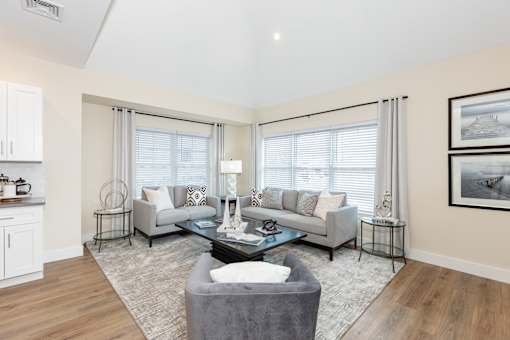 A living room with a grey couch and a coffee table.