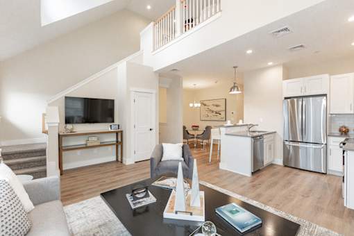 A modern living room with a staircase leading to the upper floor.