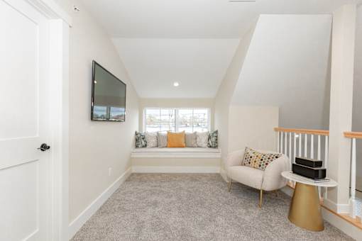 A living room with a couch, chair, and television.