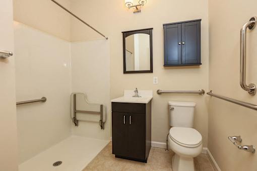 a bathroom with a toilet and a sink and a shower